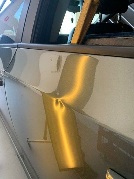 A Close-up Of a Car Door with A Dent in It — Dent Motive in Nerang, QLD