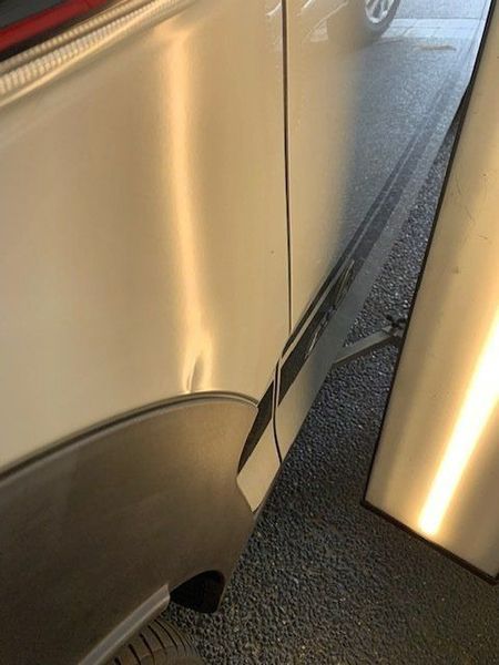 A Close-up Of a Car with A Dent on The Side of It — Dent Motive in Nerang, QLD