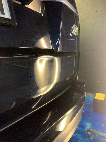 A Close-up Of a Black Car with A Damaged Bumper — Dent Motive in Nerang, QLD
