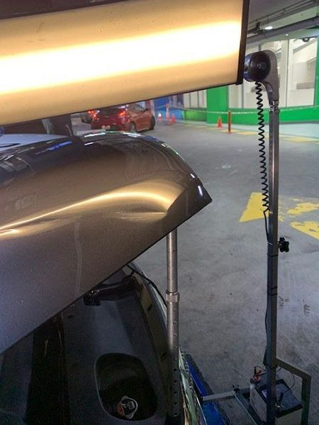 A Car Is Being Repaired in A Parking Garage — Dent Motive in Nerang, QLD