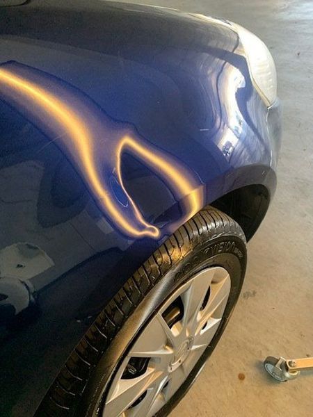 A Close-up Of a Blue Car with A Damaged Fender — Dent Motive in Nerang, QLD
