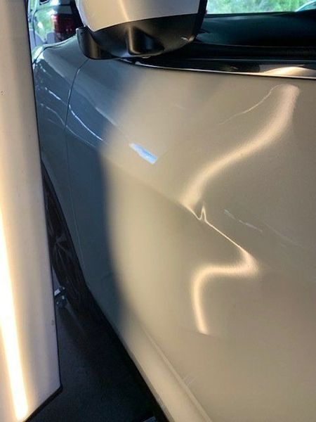 A Close-up Of a White Car with A Damaged Side Mirror — Dent Motive in Nerang, QLD