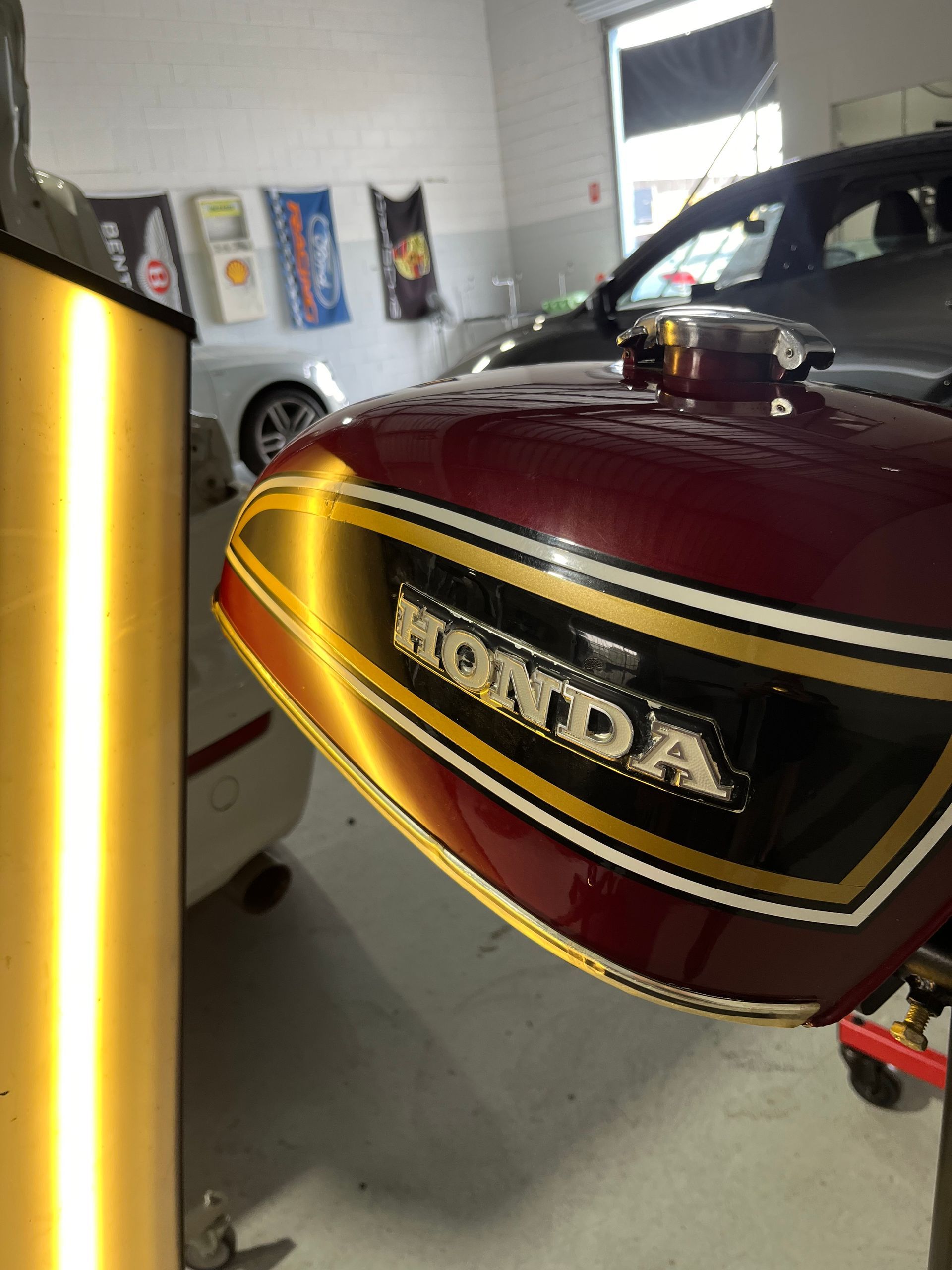 A red honda motorcycle is parked in a garage