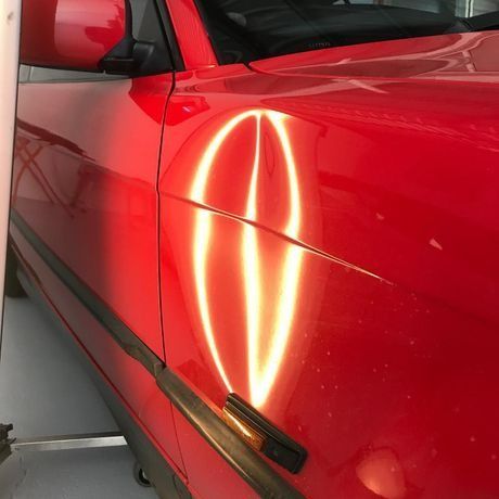 A Red Car with A Light Coming out Of It — Dent Motive in Nerang, QLD