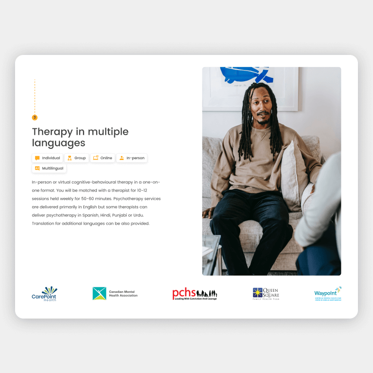 A person sits with someone for therapy. The ad promotes therapy in multiple languages.