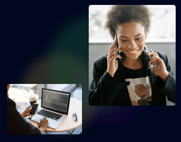 Woman using phone and laptop, smiling. Coffee cup on table, headphones around neck.