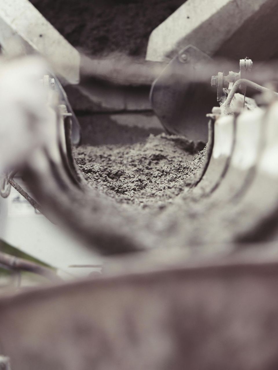 A close up of a conveyor belt with a skeleton in the background.