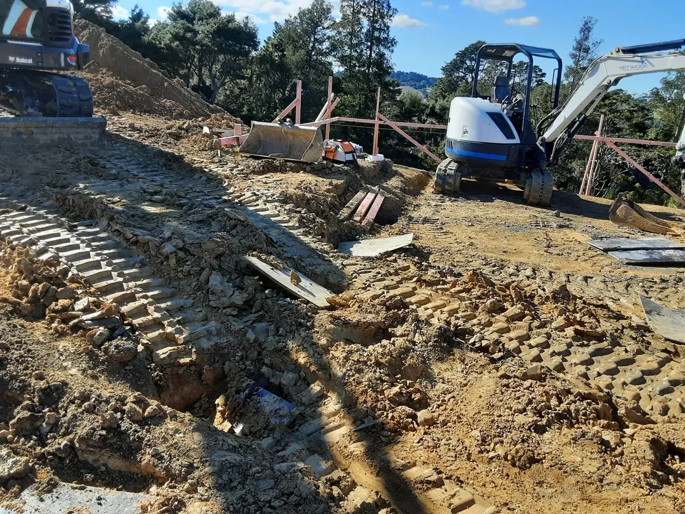A bulldozer is sitting on top of a pile of dirt on a construction site.