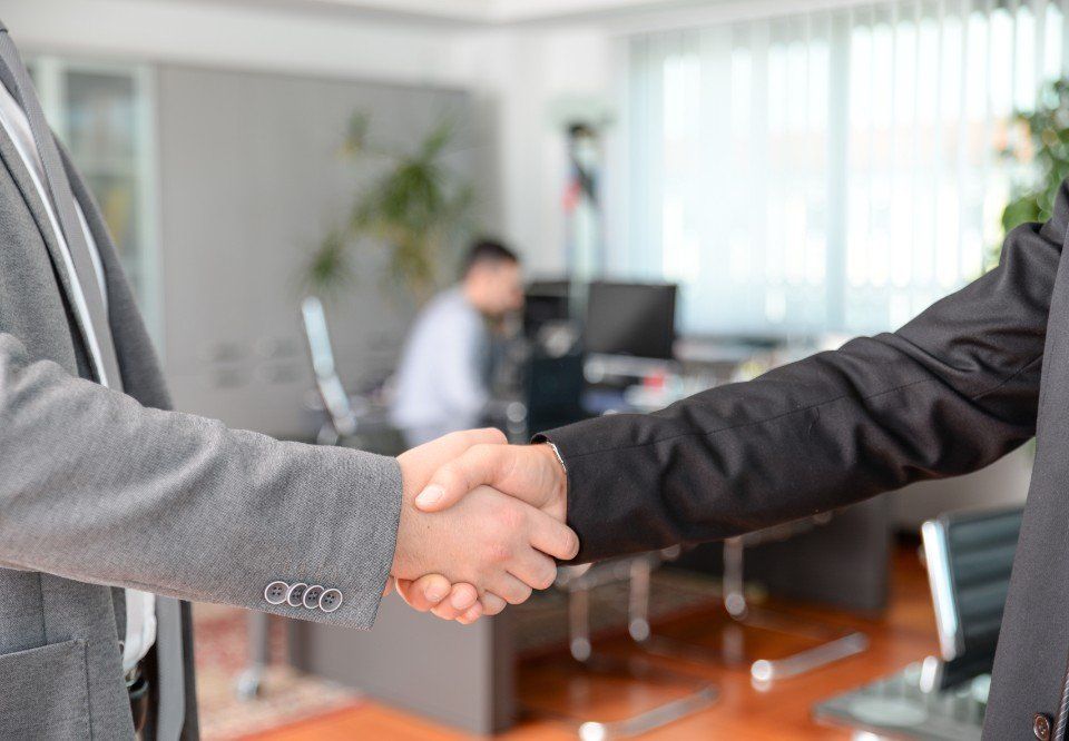 lawyer shaking a client's hand