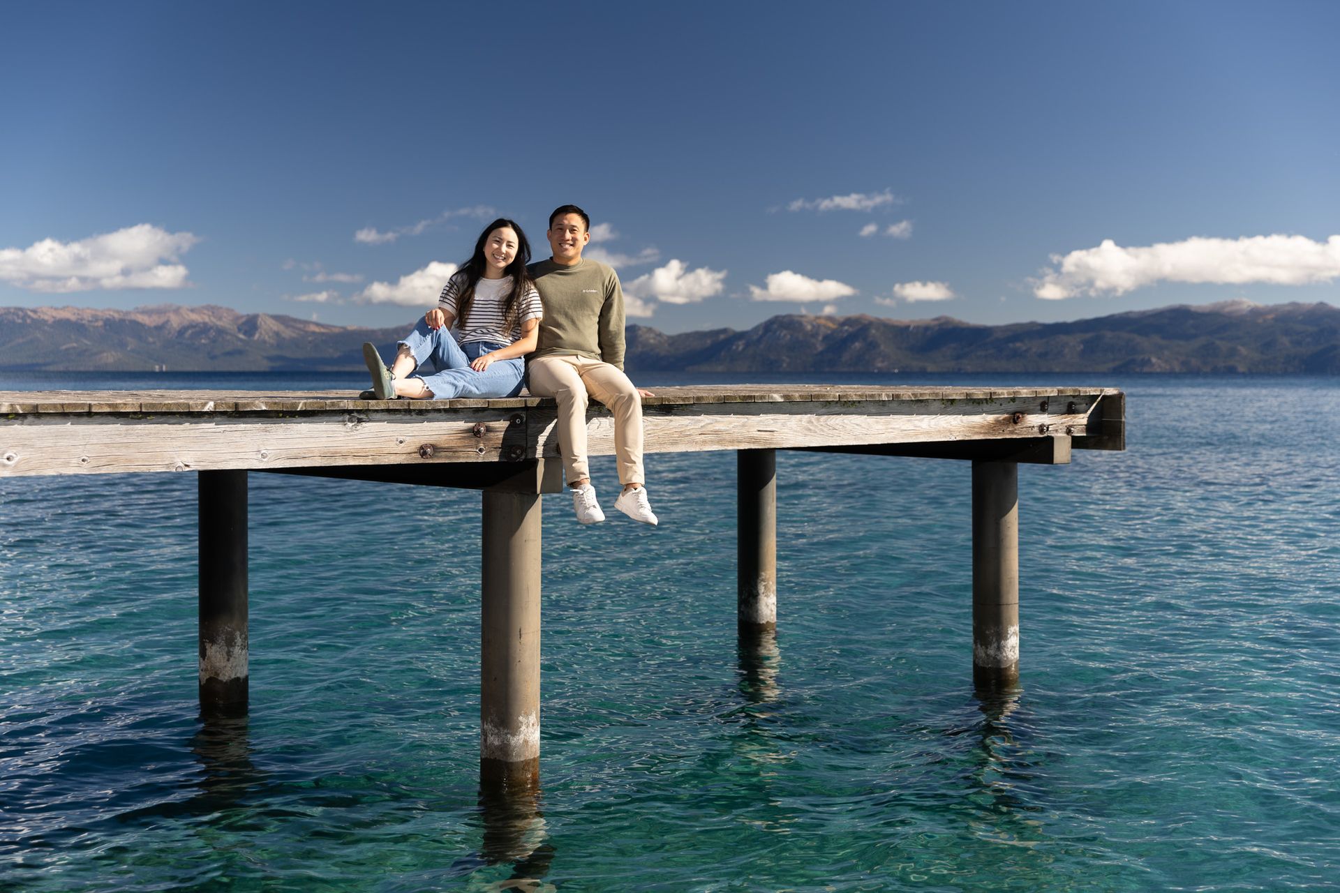 Romantic moment by the water as the newly engaged couple celebrates at sunset