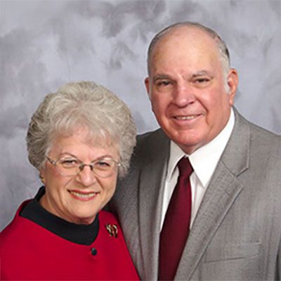A man and a woman are posing for a picture together.