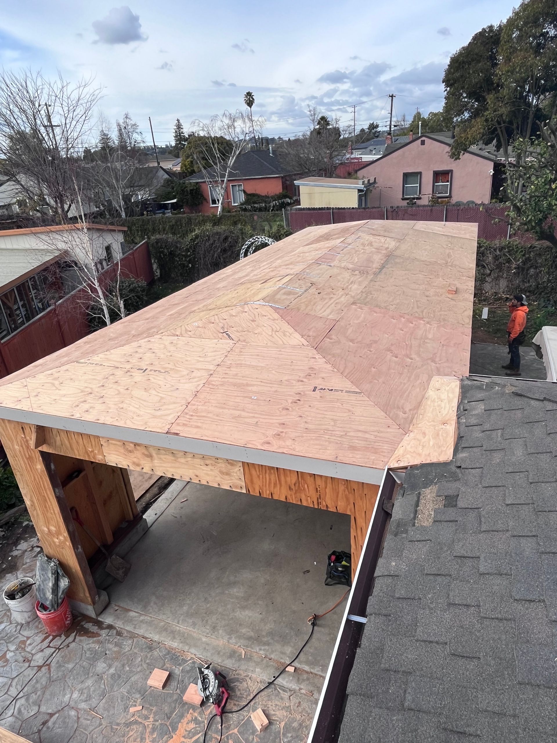 A man is working on the roof of a garage.