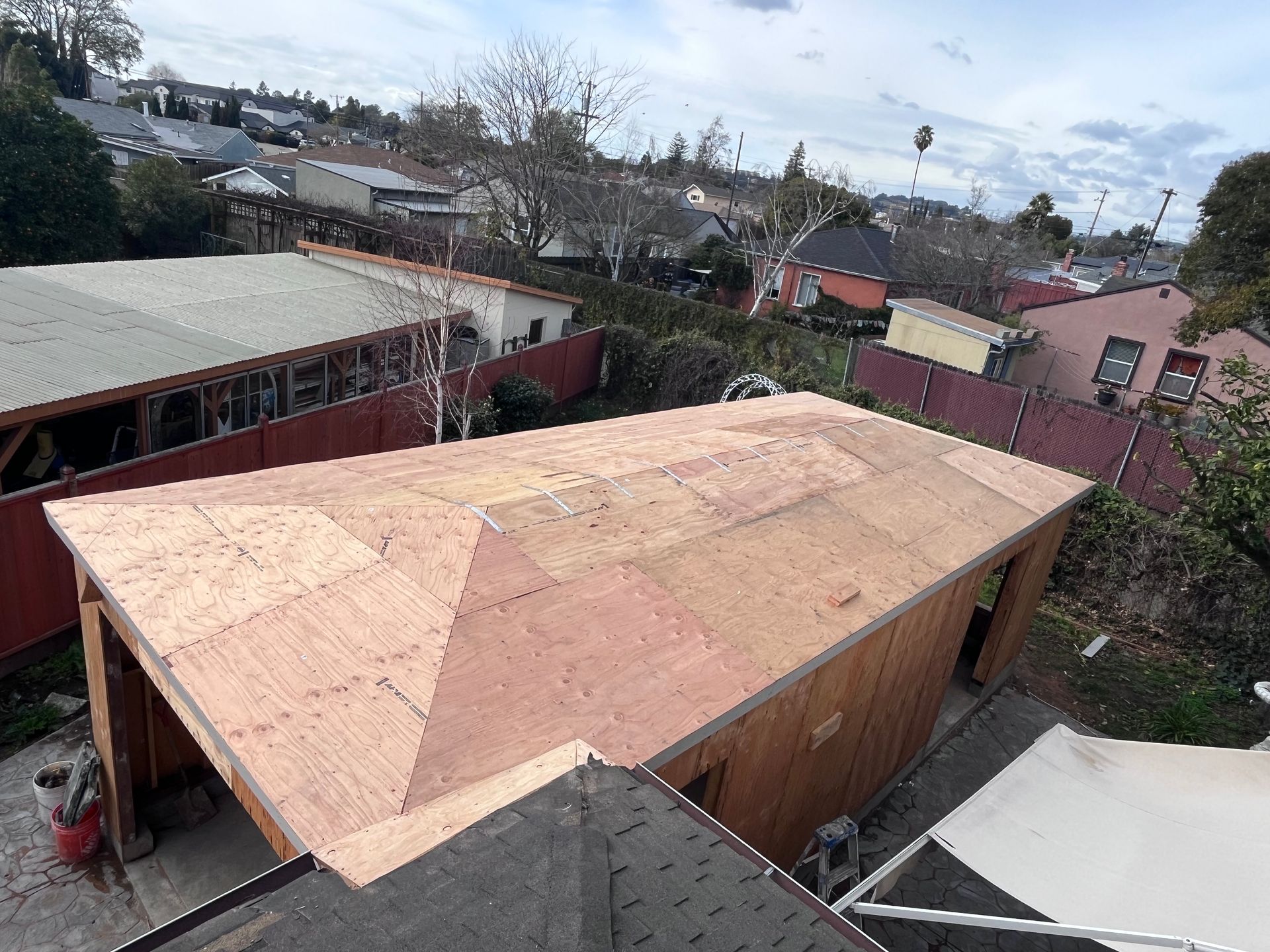 A wooden roof is being built on top of a garage.