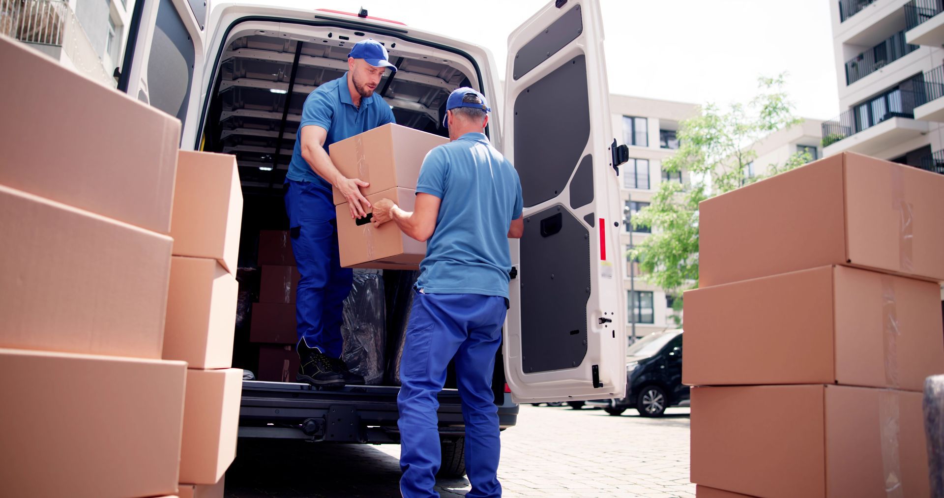 Two movers unloading cardboard boxes