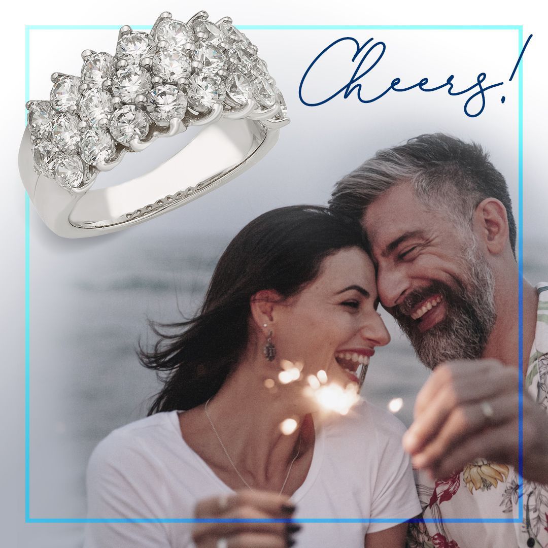 Diamond ring with joyful couple holding sparklers.