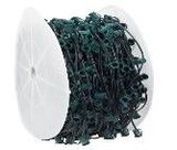 A spool of green christmas lights on a white background.