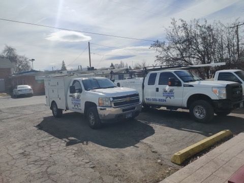 A man is fixing a dishwasher in a kitchen.
