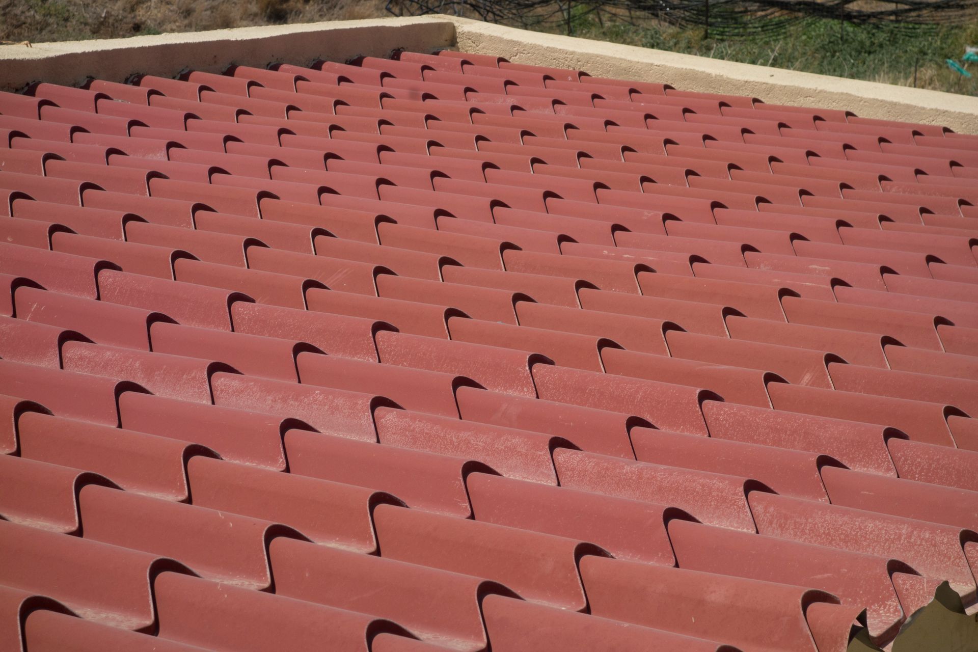 A red roof with a lot of holes in it