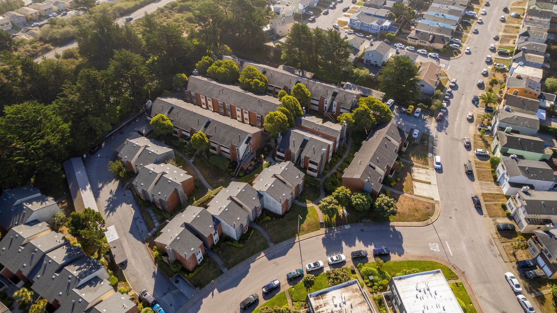 An aerial view of a residential area with lots of houses and trees.