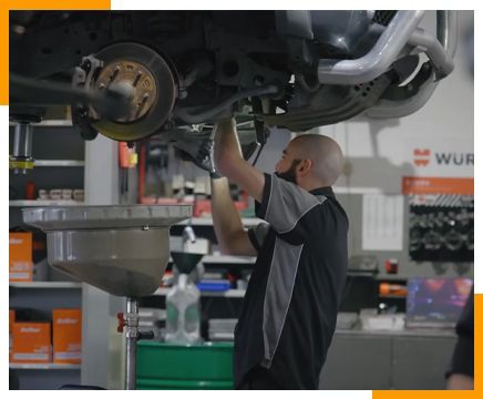 Man in Blue Checking Car at Chris Colgrave Automotive Launceston