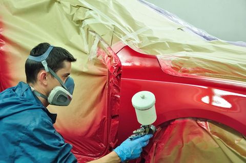 Worker Painting A Red Car — Summerville, SC — Hoelz’s Body Shop