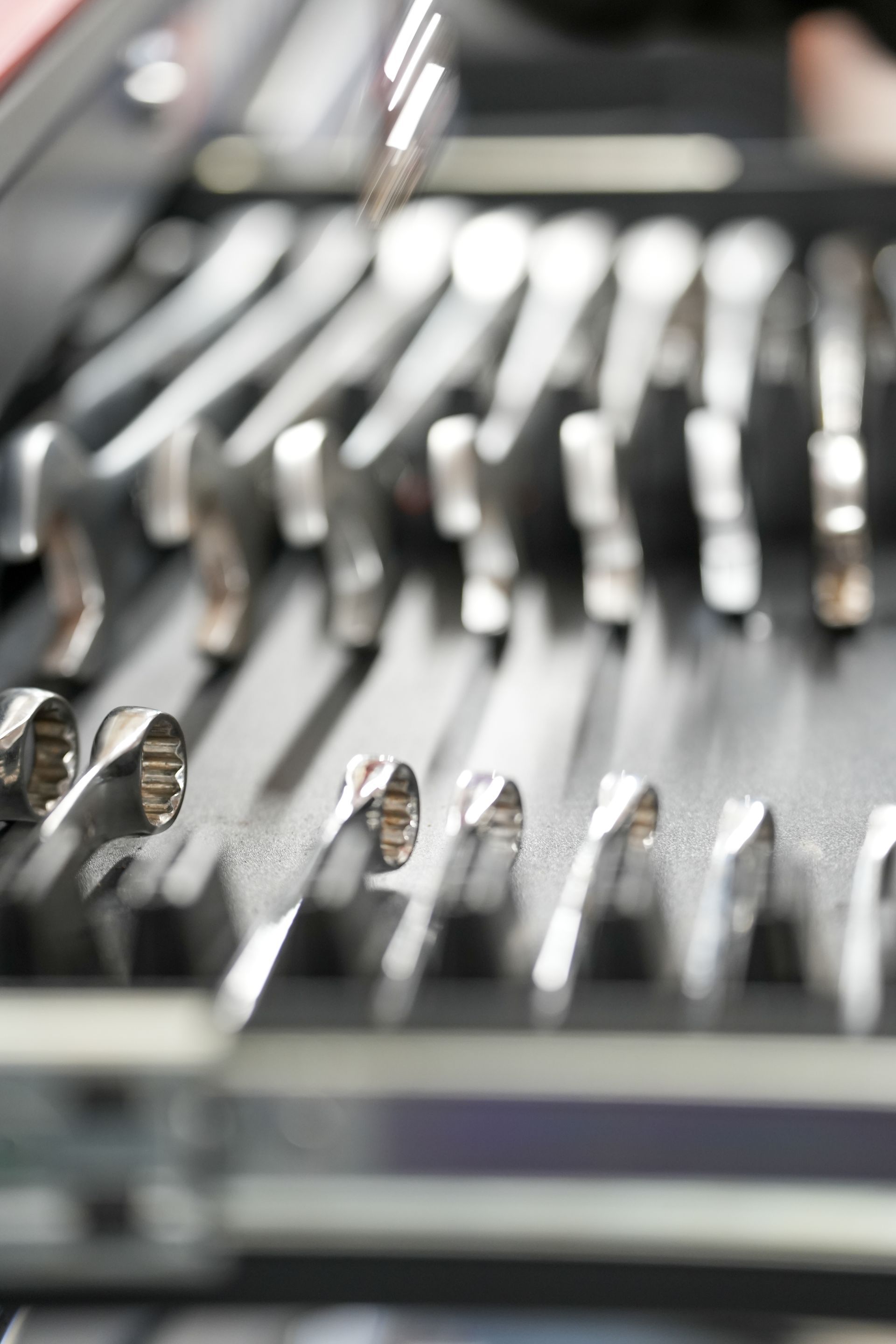 close up shot of spanners aligned neatly in a tool box draw