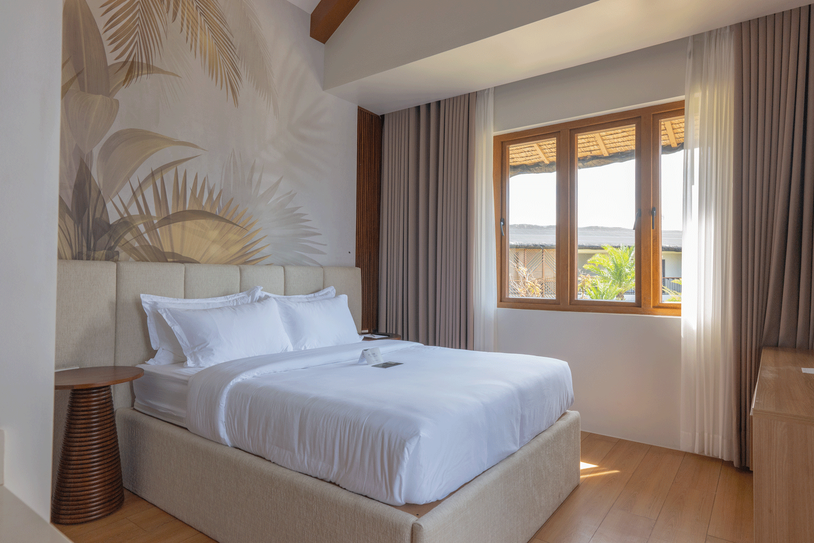 A hotel room with a large bed and a flat screen tv.