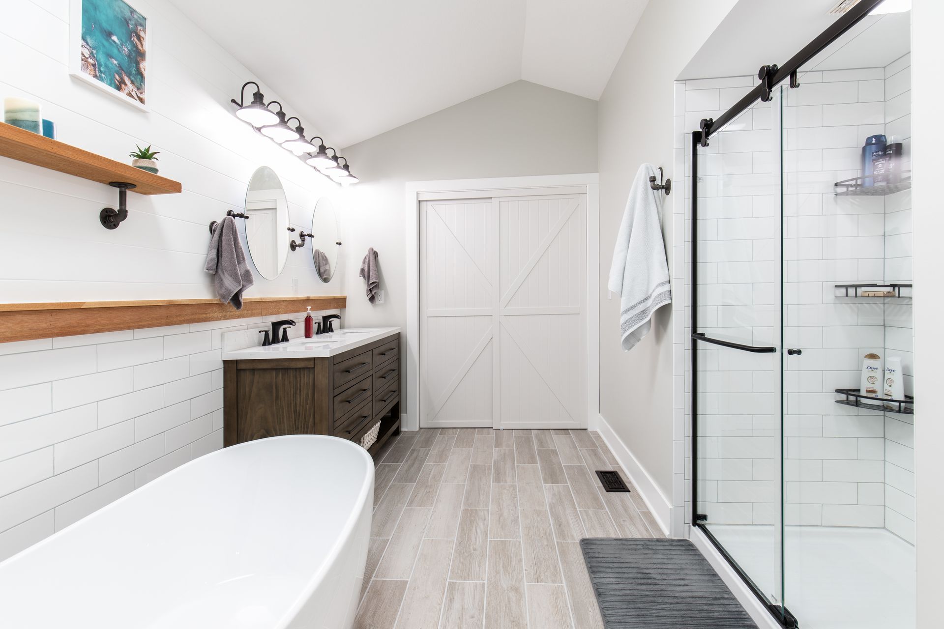 A bathroom with a tub, sink, and shower.