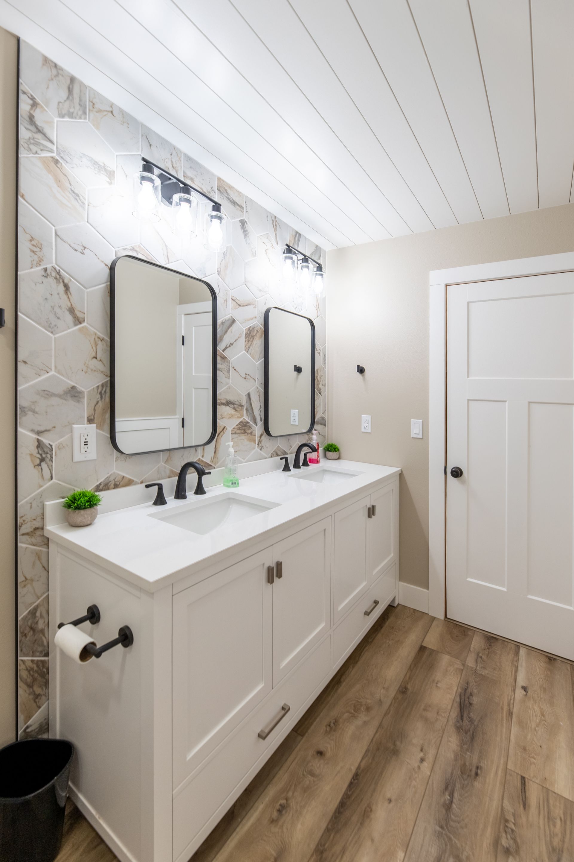 A bathroom remodel with two sinks and two mirrors.