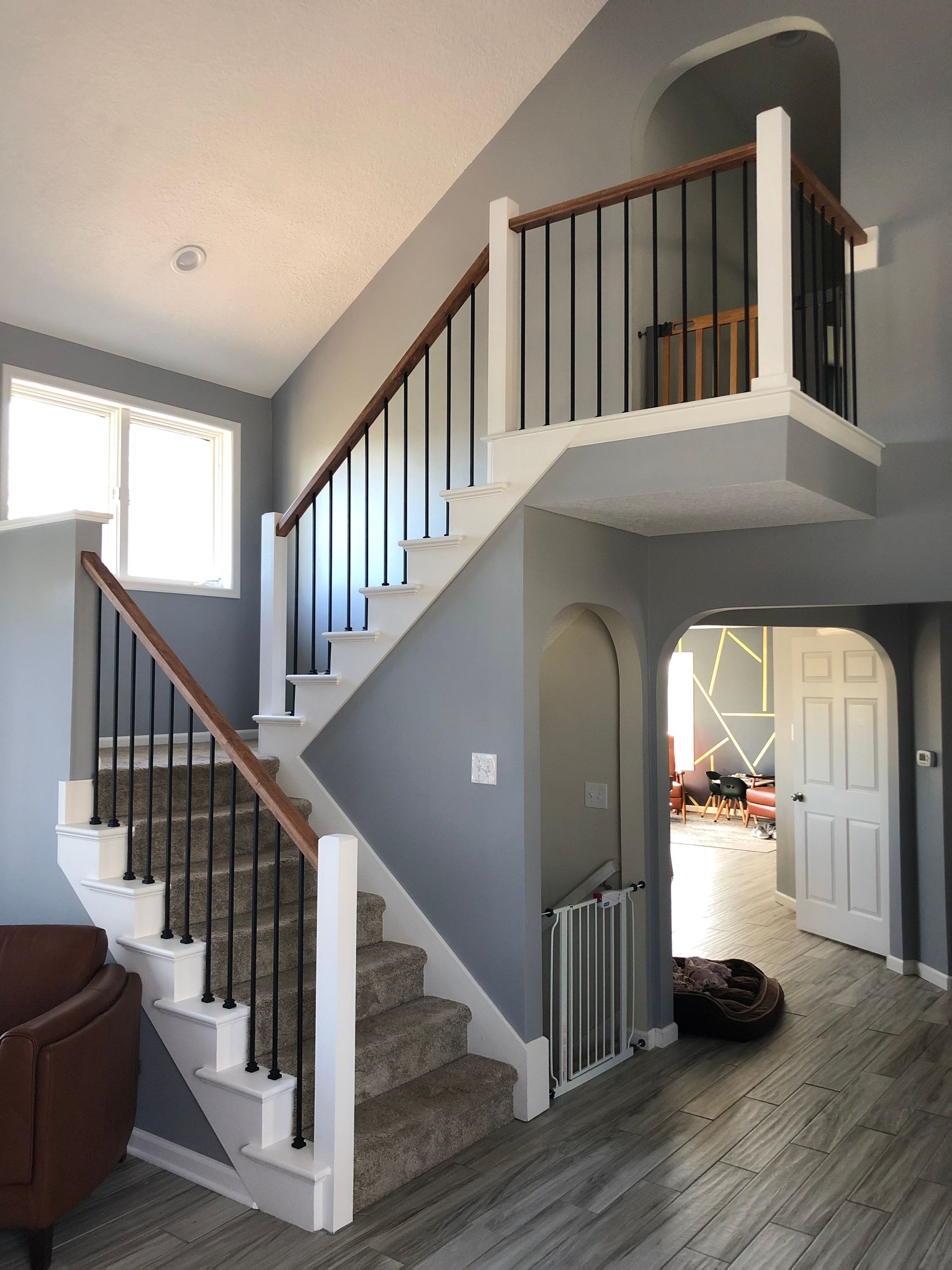 A staircase leading up to the second floor of a remodeled house