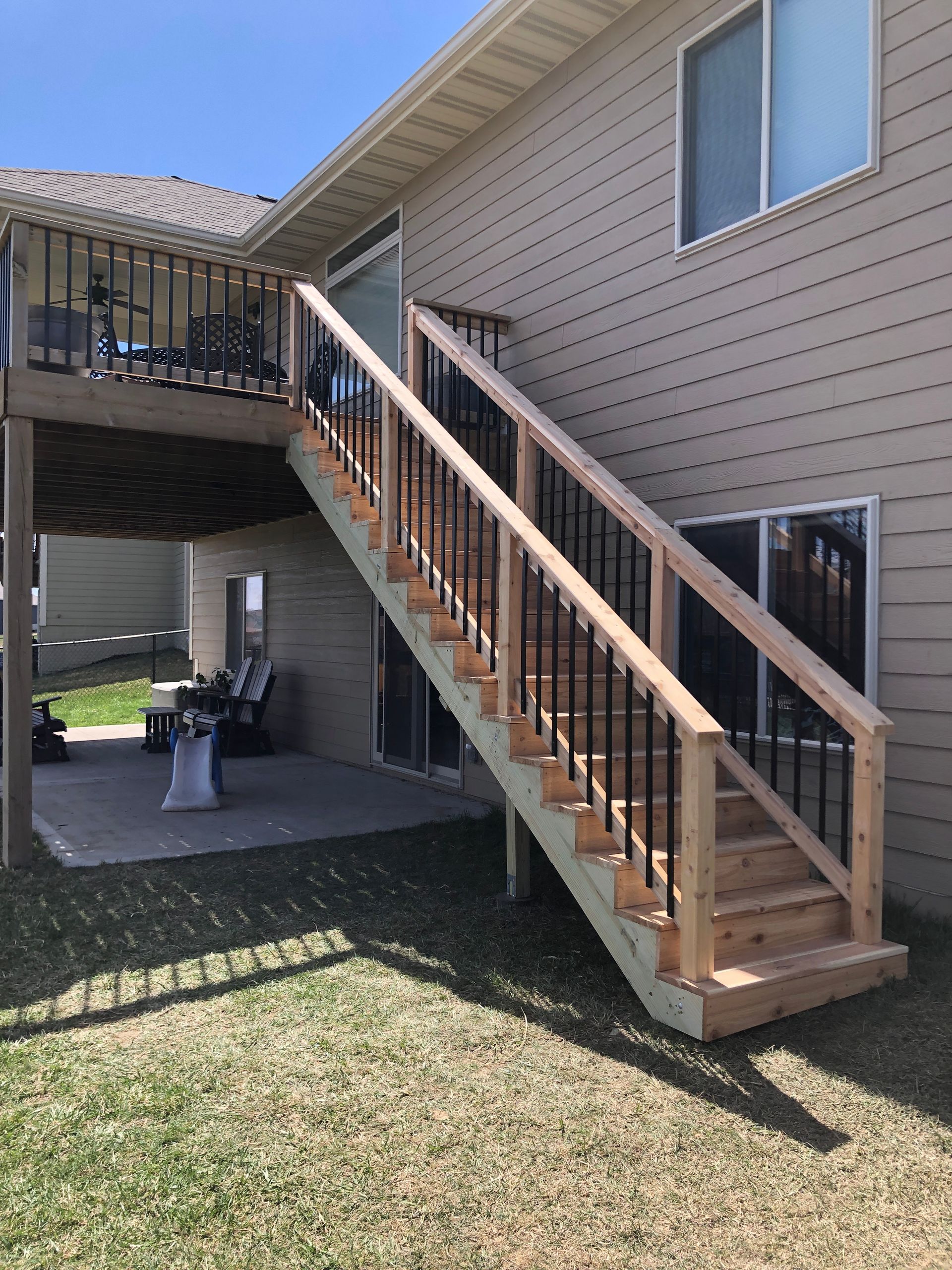 A house with a deck and stairs leading up to it