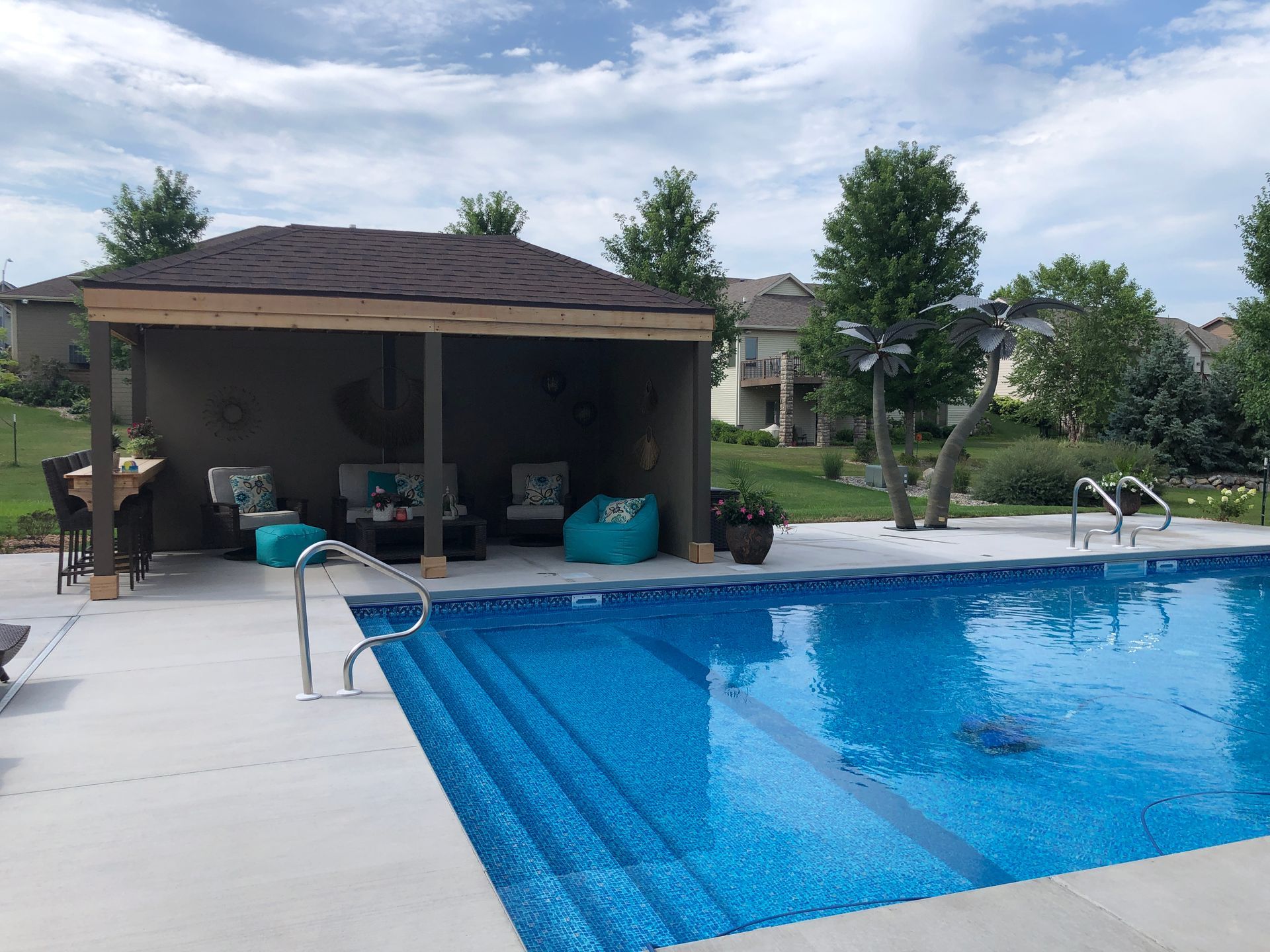 A large swimming pool with a gazebo in the background.