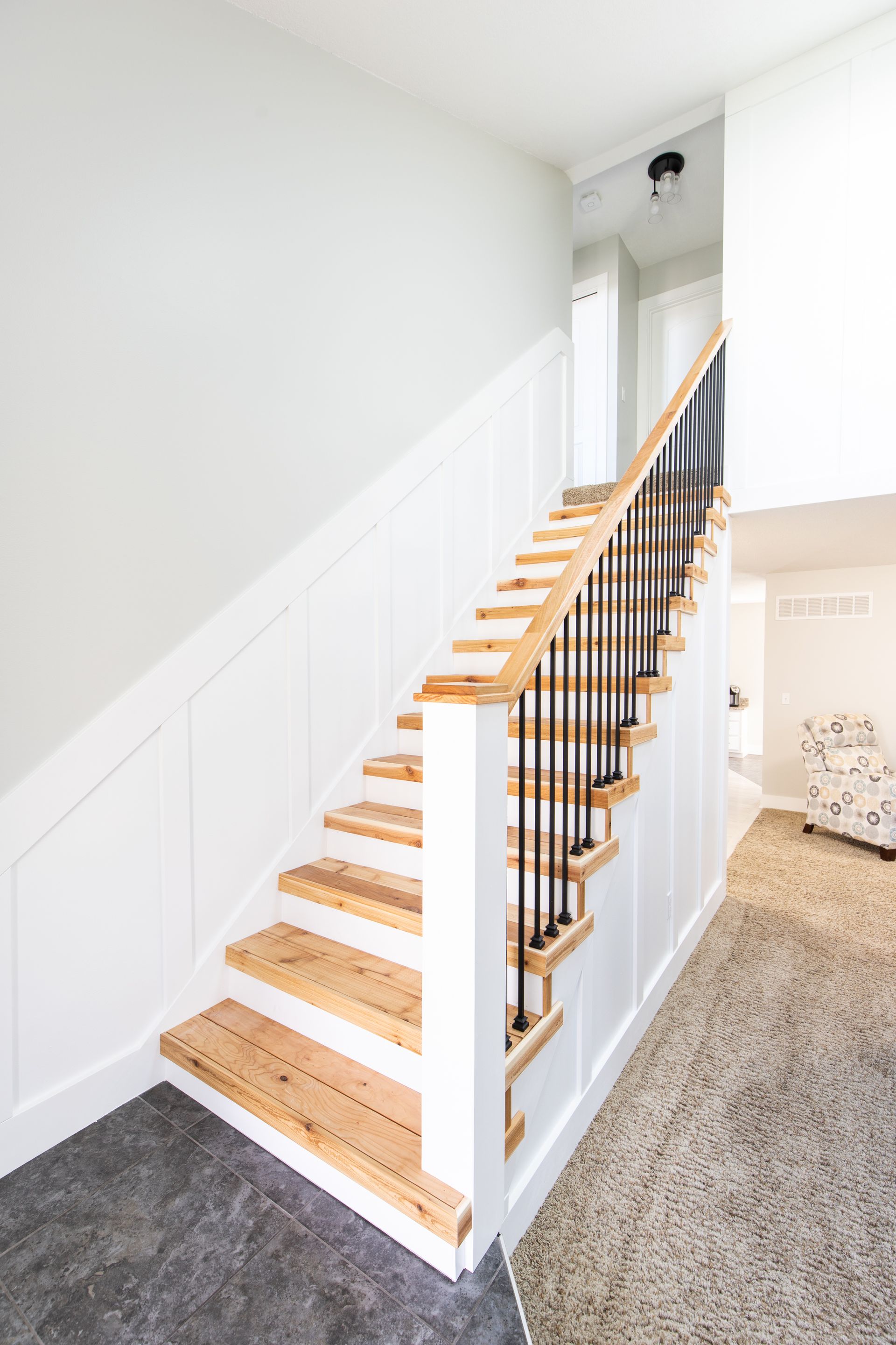 A staircase with wooden steps and a metal railing in a living room.