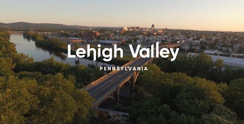 Banner reading “POSSIBLE” over a mountain valley in white text on a scenic landscape.