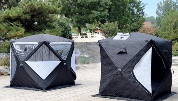 Two sauna tents are sitting next to each other on a patio.