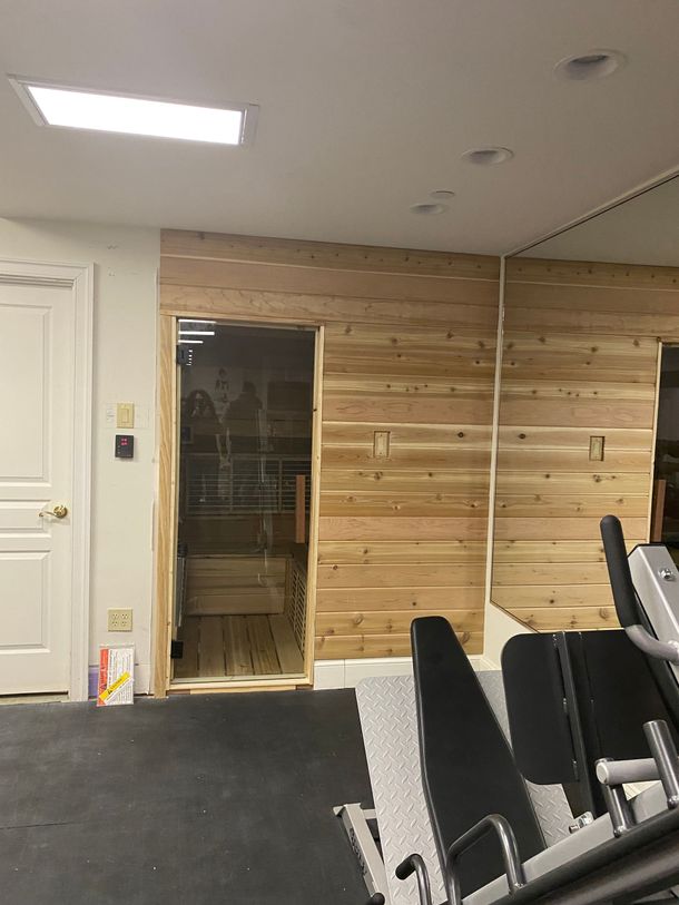 6 person indoor hybrid infrared sauna. Inside a private gym