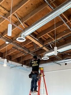 Man Fixing the Light in Warehouse - Los Angeles, CA - Gomez Electric Inc