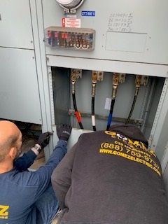 Two Men Working on Electrical Box - Los Angeles, CA - Gomez Electric Inc