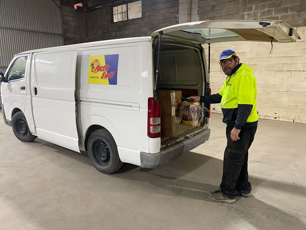 Worker At The Back Of A Van — Professional Transport in Taree South NSW