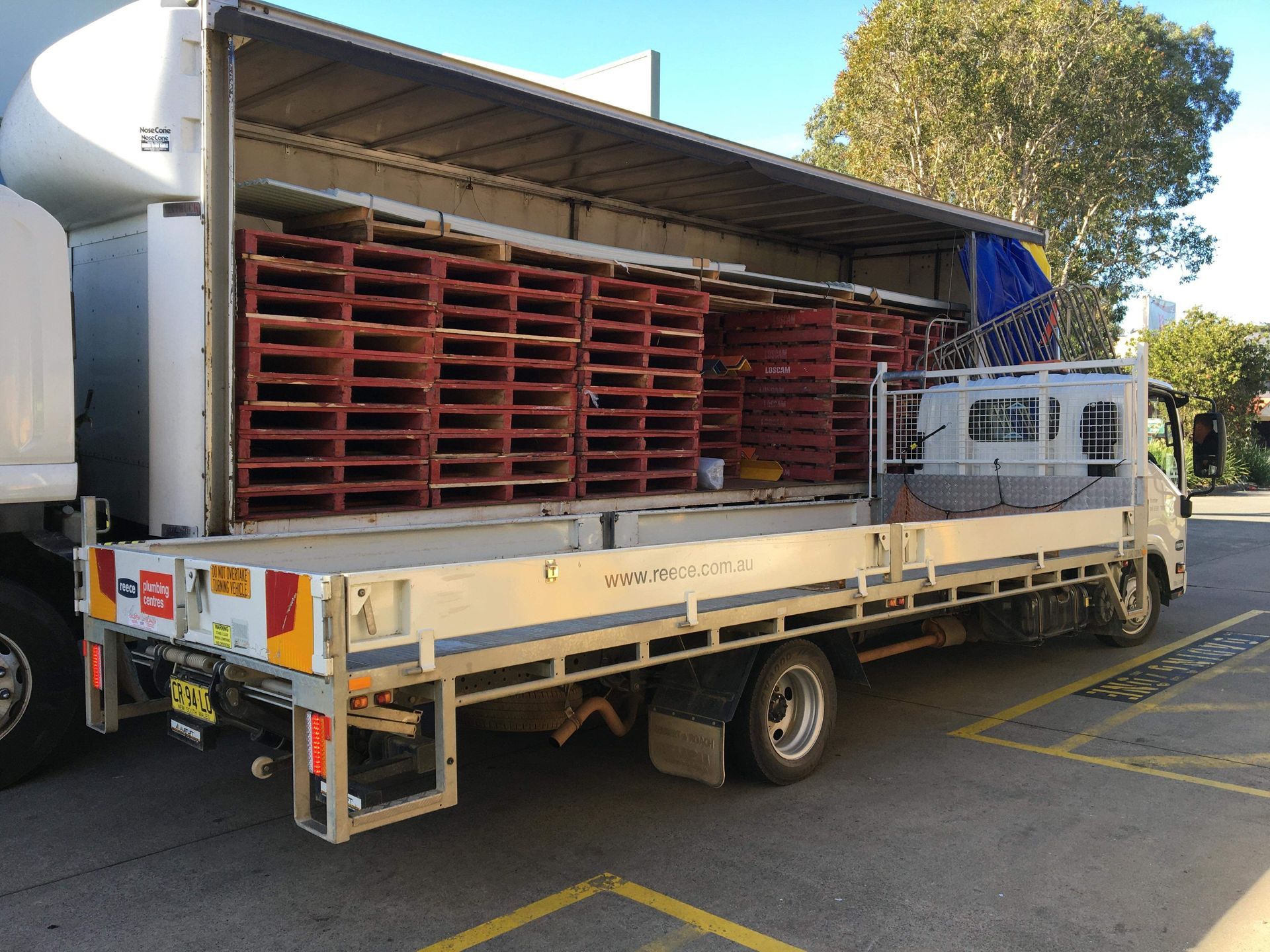 Red Pallets In Transport Truck — Professional Transport in Port Macquarie, NSW