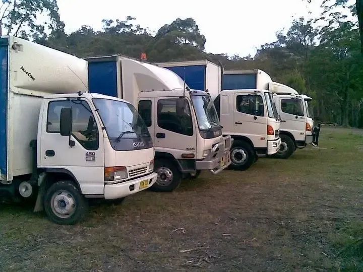 Row Of Blue And White Trucks — Professional Transport in Newcastle, NSW
