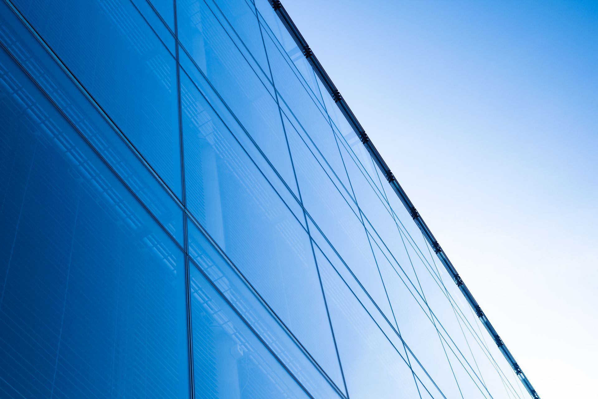 Modern glass wall building with a mesh pattern.