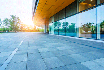 Modern office building exterior with pristine windows after expert business glass maintenance service. Modern office building exterior with pristine windows after expert business glass maintenance service.