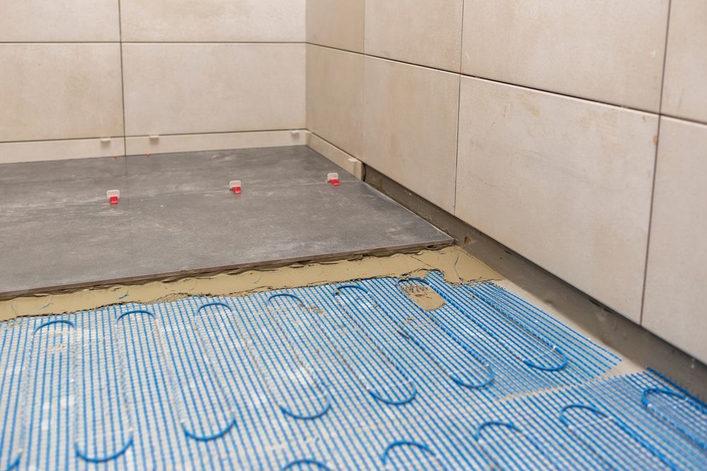 a tile floor is being installed in a bathroom with heating tubes