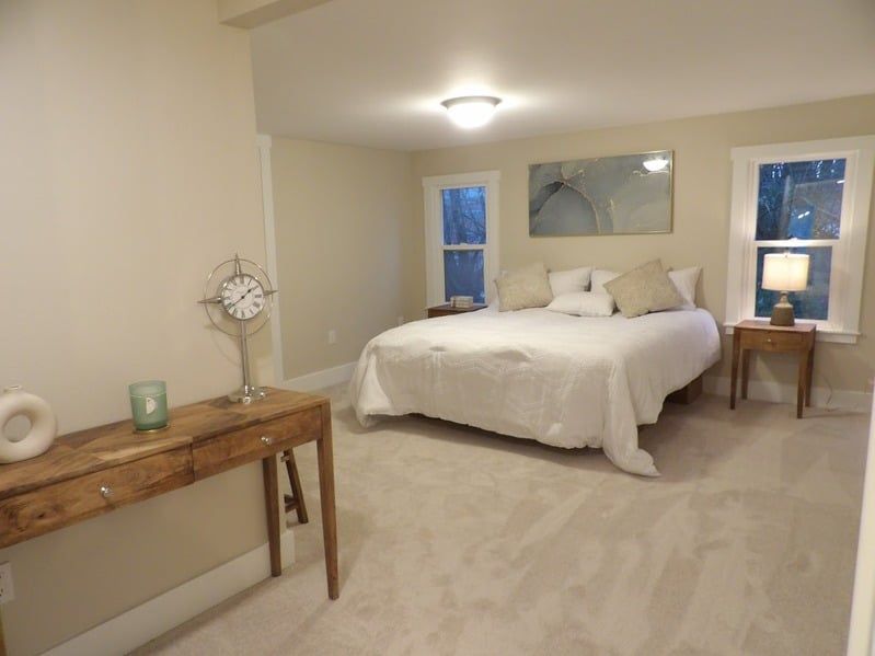 A bedroom with a large bed and a wooden table