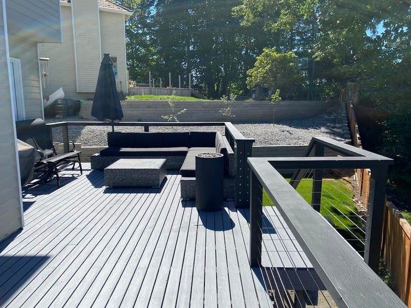 A deck with a couch and umbrella on it