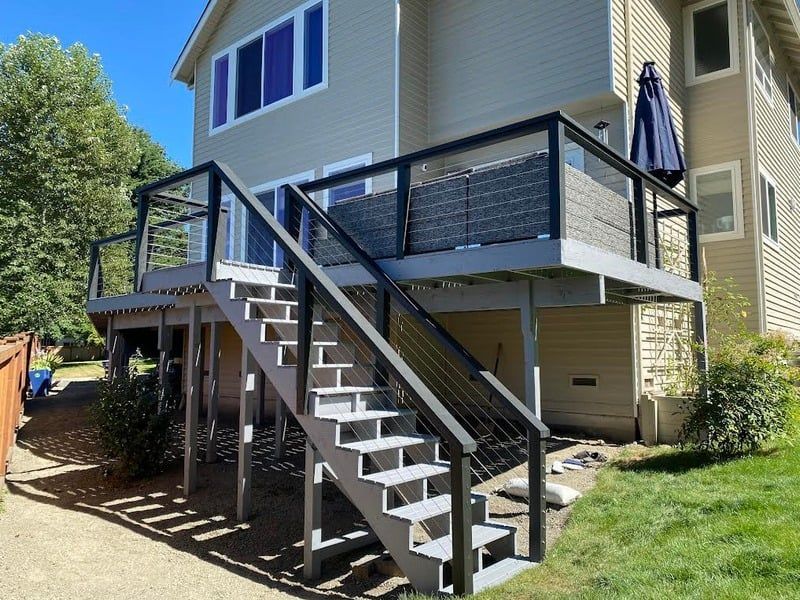 A house with a deck and stairs leading up to it