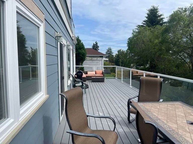 A large deck with a table and chairs on it