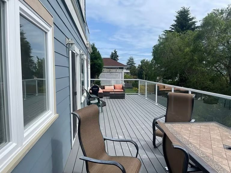 A large deck with a table and chairs on it