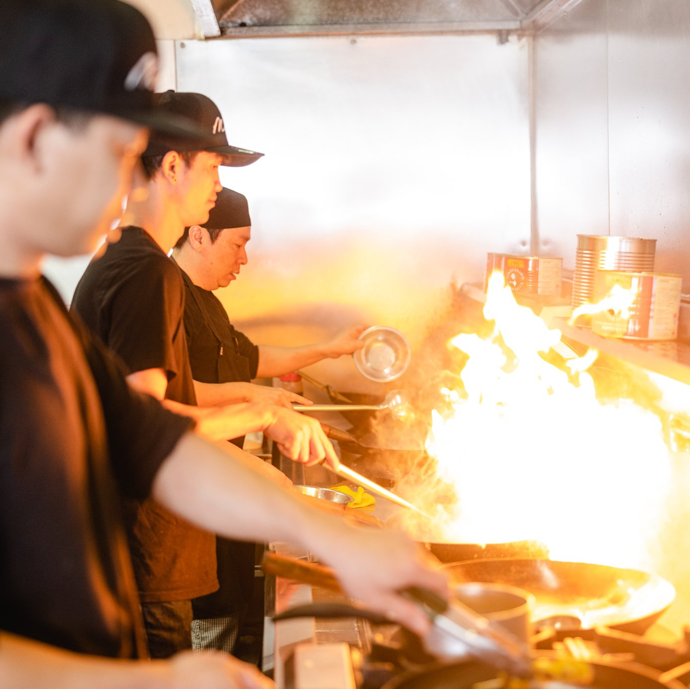 Kitchen Staff cooking on hot surface — Thai Food in Nelson Bay, NSW